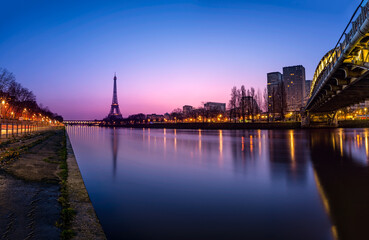 Cityscape of Paris with the Eiffel tower during the Blue hour before sunrise. The Rouelle bridge is on the right.