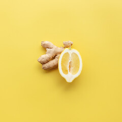 Half of lemon and ginger on yellow background