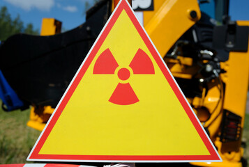 Radiation hazard sign, trees and truck on a background