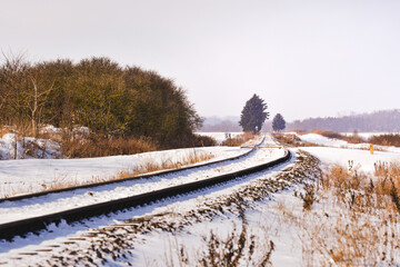 Railroad tracks in snow, winter landscape.