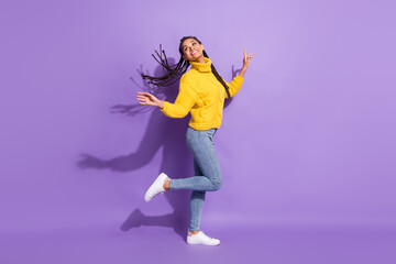 Fototapeta na wymiar Full size profile photo of optimistic funky brunette girl dance wear sweater jeans sneakers isolated on purple background