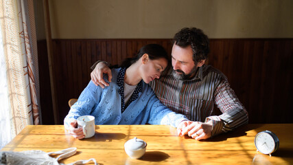 Portrait of happy poor mature couple resting indoors at home, poverty concept.