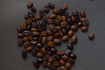 Close-up of roasted coffee beans of different kinds on gray background with copy space. Wallpaper