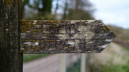 Traditional Old Wooden Public Footpath Sign in English countryside