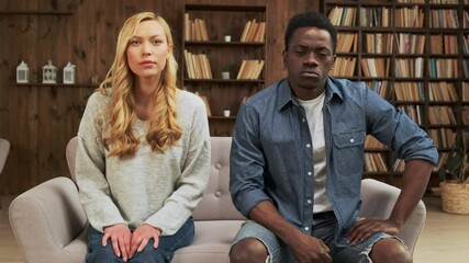 Young mixed race ethnicity couple having marriage counselling. Interracial couple meeting with consultant