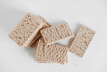 Rye crisp bread on a white wooden background. Top view. Copy, empty space for text
