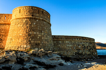 Fototapeta na wymiar Fortress called San Miguel in Los Escullos beach in Almeria