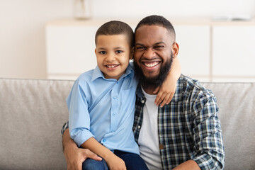 Happy African American Daddy And Son Hugging Posing At Home