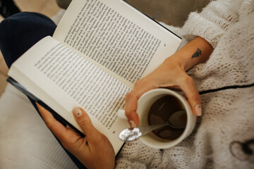 woman reading a book with a coffee