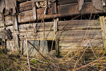 close up of abandoned rustic old wooden house wall