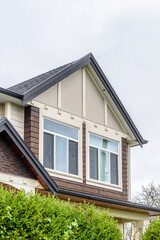The top of the house or apartment building with nice window.