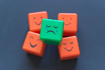 Positive and negative emotions concept, funny faces drawn on cubes.