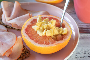 healthy breakfast plate with open faced sandwiches and grapefruit topped with banana pieces