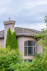 The top of the house or apartment building with nice window.