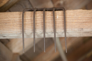 Metal Rake over a wooden Beam