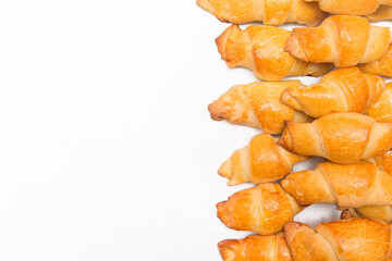 Fresh homemade cakes. Buns. Croissants isolated on white background, culinary composition, copy space and mock up