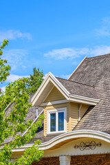 The top of the house or apartment building with nice window.