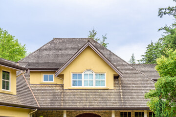 The top of the house or apartment building with nice window.