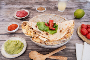 Close-up of Mexican quesadillas, with guacamole, tomatoes and spices