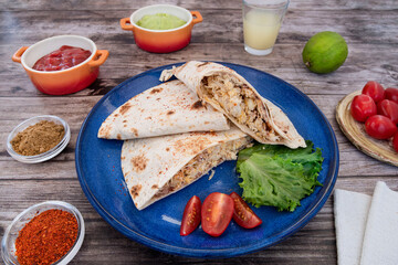Close-up of Mexican quesadillas, with guacamole, tomatoes and spices