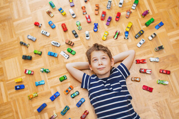 Boy with his colorful toy car collection