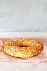 Simit Turkish crispy braided bagel with sesame seeds. Turkish homemade traditional pastries. Side view. Close-up. Copy space.