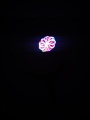 Closeup of Neon Multicolored Spirograph geometric abstract pattern isolated on a Black background with copy space. Made using Long exposure technique.Geometry. Pendulum pattern. © sanju's view