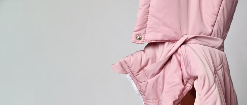 close-up of the hood from a pink padded jacket. there is a place for your advertisement