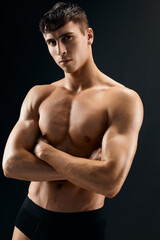 Fototapeta na wymiar sexy man with a pumped-up torso athlete dark background studio