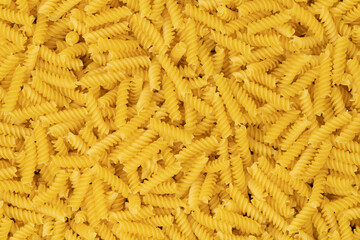 raw spiral pasta background texture