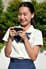 A Happy Teen Female Using Cellphone