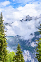 The Swiss Alps at Murren, Switzerland. Jungfrau Region. Tops of the mountains in fog and clouds.