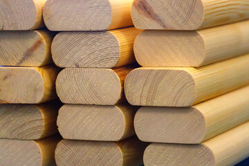 The planed wooden blanks are stacked in a stack. Supply and manufacture of building materials made of wood.