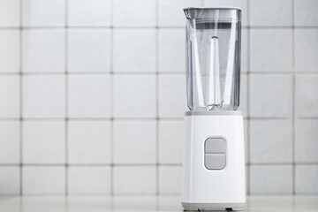 White electric blender on the kitchen table.