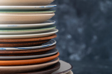 Many empty plate on black background, close up