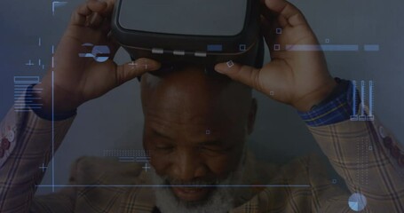 Digital interface with data processing against african american senior man removing vr headset - Powered by Adobe
