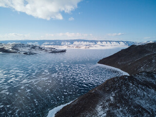 view from the drone on the hilly coast of the island of Olkhon and the frozen Lake Baikal. Siberia Russia