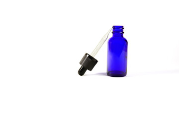 blue glass bottles.A bottle with a pipette, isolated on a white background. glass container for cosmetic skin care products. Aromatherapy, essence, or perfume is empty. a bottle of cosmetic dropper.