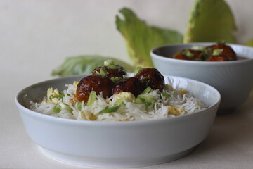 Steamed basmati rice with scrambled eggs and spring onions, called egg rice served along with Vegetable Manchurian