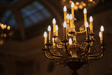 antique bronze candlestick with bulbs and monograms.