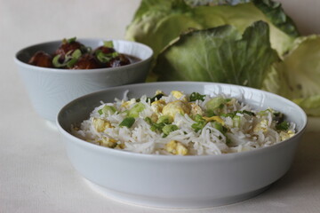 Steamed basmati rice with scrambled eggs and spring onions, called egg rice served along with Vegetable Manchurian