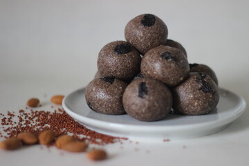 Laddu with finger millet seeds. Laddu is a sphere shaped sweet and it is primarily made from flour, fat and sugar, but here the flour is made with finger millets or Ragi.