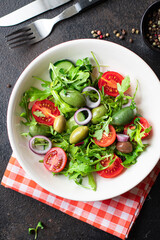 fresh salad vegetables olives tomato, cucumber, lettuce mix leaves snack trend meal copy space food background rustic. top view keto or paleo diet vegan or vegetarian food