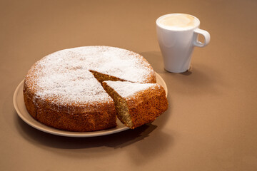 An ancient Roman cake made of almonds and dry bread with fresh cappuccino (Antica torta alle mandorle e pane)