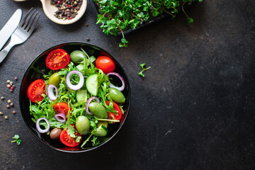 fresh salad vegetables olives tomato, cucumber, lettuce mix leaves snack trend meal copy space food background rustic. top view keto or paleo diet vegan or vegetarian food