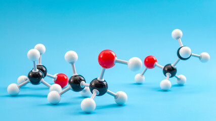 Molecular structure of chemical compounds and organic chemistry concept with educational plastic model of ethanol molecule isolated on blue background - 428844446