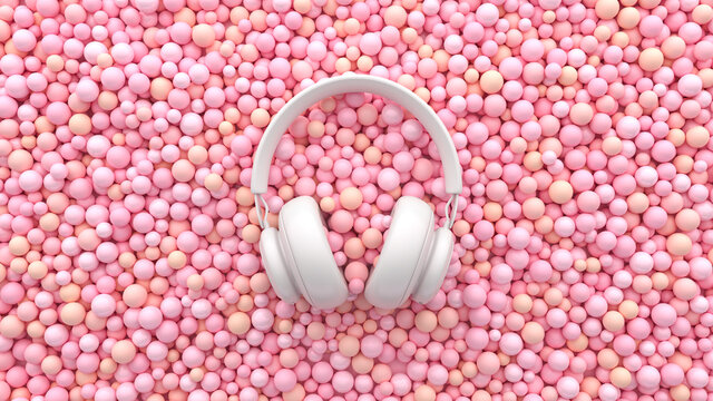 A white headphone on soft pink balls. Minimal musical flat lay concept. Advertisement ASMR idea. 3d render