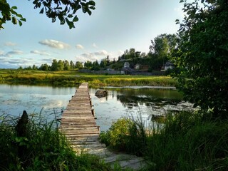 Fototapeta na wymiar wooden bridge over lake