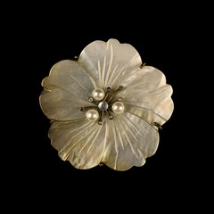 Round antique brooch with a flower shape. Vintage brooch in the shape of a flower