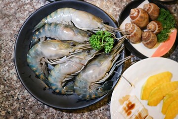 raw prawn, raw shrimp and Spotted babylon or Babylonia areolata or shell